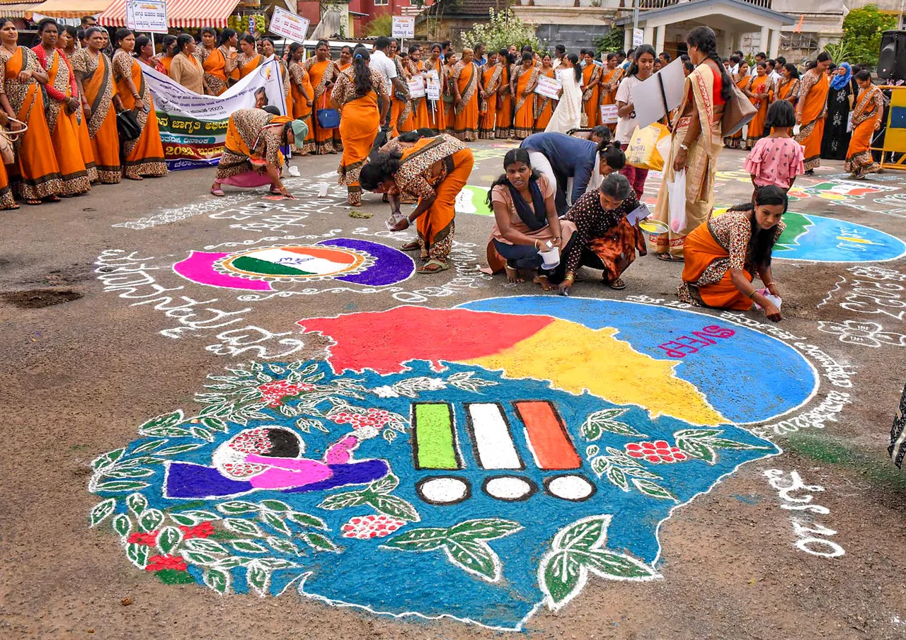 District administration workers create a 'rangoli' to spread voting awareness ahead of upcoming Karnataka Assembly elections