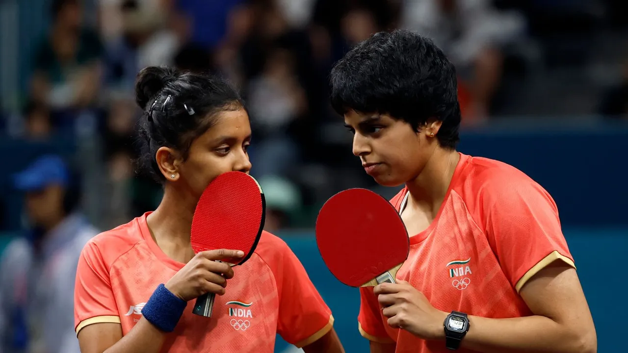 Sreeja Akula (L) and Archana Girish Kamath of India speak with each other during their match against Yuan Wan and Shan Xiaona of Germany