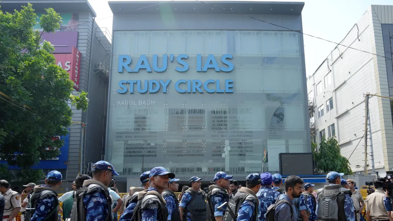Security personnel stand guard near a UPSC exam coaching centre after three civil services aspirants died when the basement of the coaching centre was flooded following heavy rain, in New Delhi, Sunday, July 28, 2024.