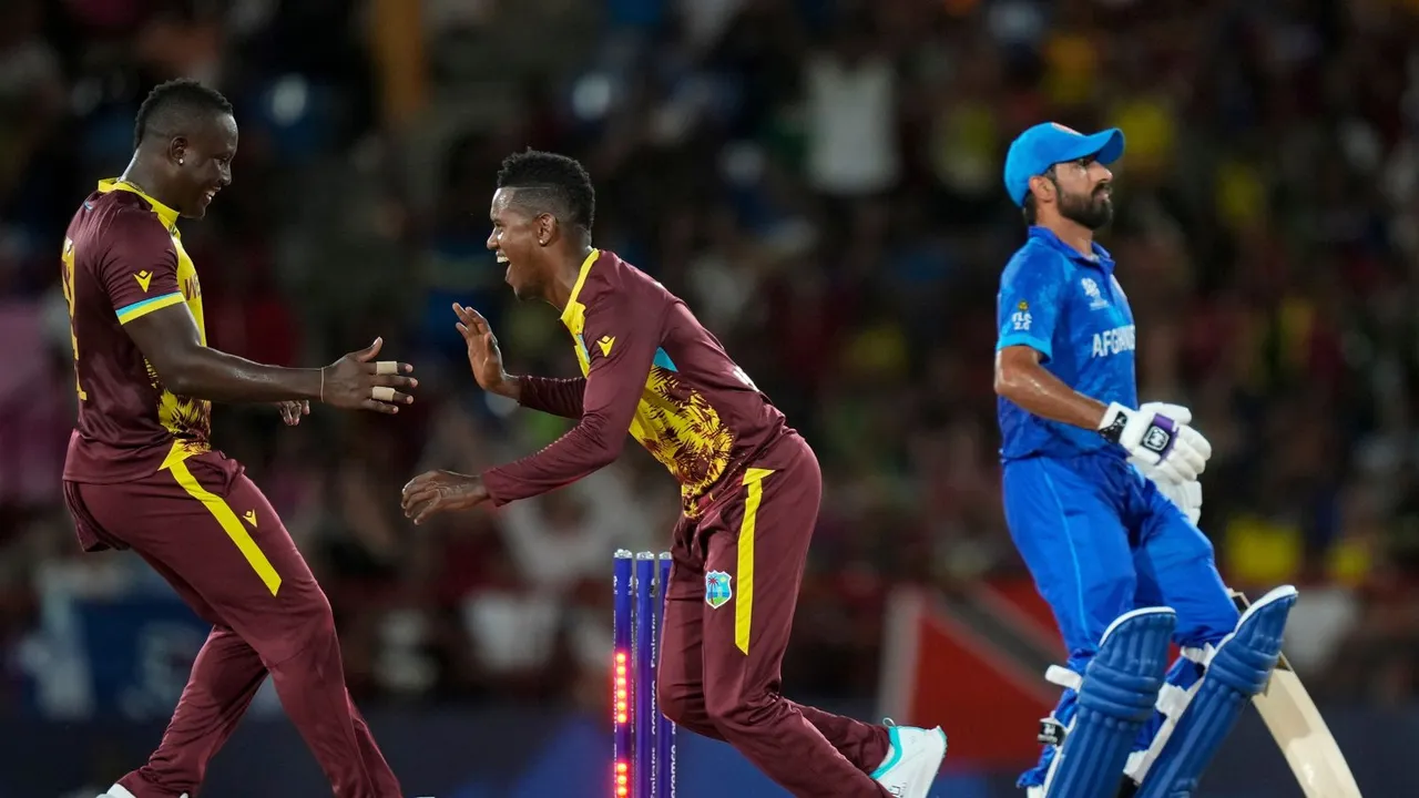 West Indies' captain Rovman Powell, left, celebrates with Akeal Hosein the dismissal of Afghanistan's Karim Janat during an ICC Men's T20 World Cup cricket match