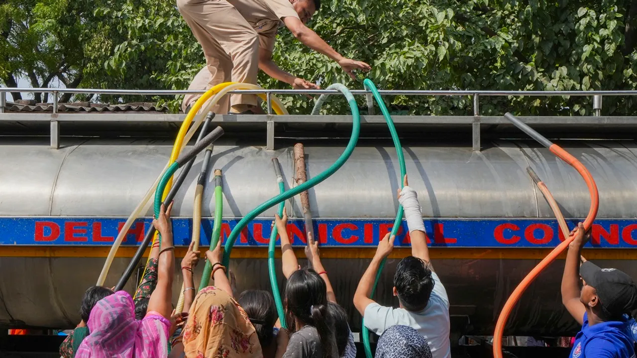 Residents fill water from a tanker amid water crisis, at the Vivekanand Camp in Chanakyapuri area of New Delhi, Friday, May 31, 2024