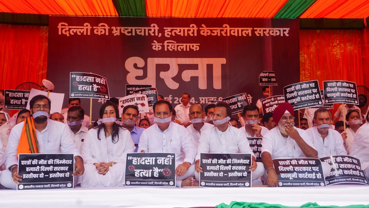 Delhi BJP President Virendra Sachdeva with MP Bansuri Swaraj and other leaders stages a protest against the Delhi government over the death of three civil services aspirants due to drowning, at Rajghat, in New Delhi, Tuesday, July 30, 2024.