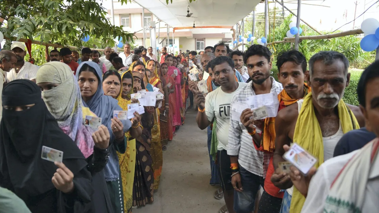 Voters show their ID cards as they wait to cast their votes for the fifth phase of Lok Sabha elections, in Hajipur, Monday, May 20, 2024