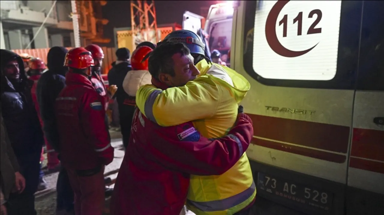 A survivor in Turkey hugs rescue worker