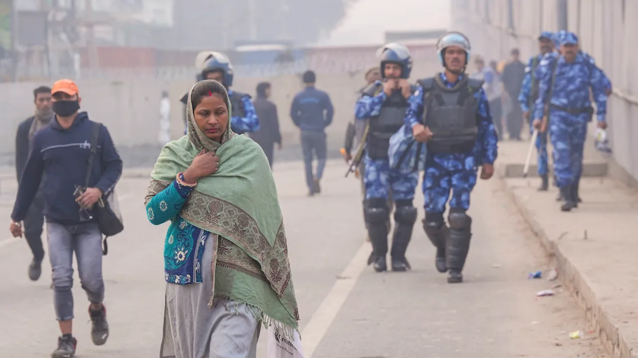 Commuters near Singhu border amid tight security arrangements in view of farmers' 'Delhi Chalo' march, in New Delhi, Tuesday, Feb. 13, 2024.