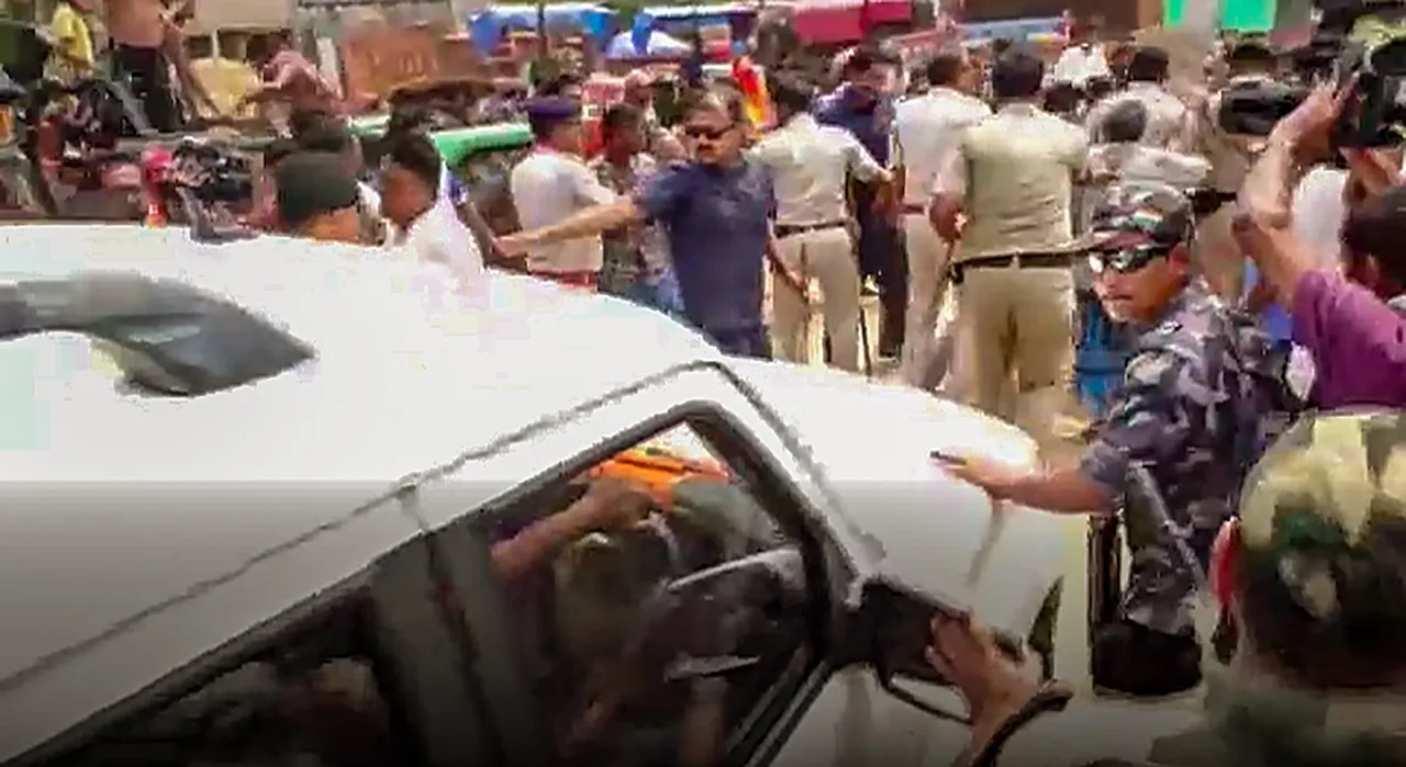 Police intervene as BJP candidate Dilip Ghosh's convoy is stopped after clahes between supporters of TMC and BJP while he was on his way to a polling booth following complaints of booth jamming, in Susunia area of Bardhman, Monday, May 13, 2024. TMC supporters allegedly blocked his convoy and squatted in front of his vehicle, starting a protest against him. 