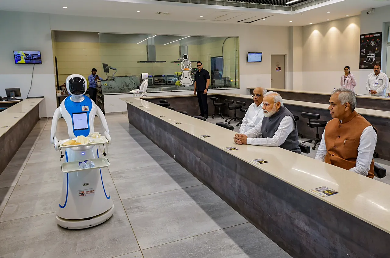 Prime Minister Narendra Modi being served tea by robots at Science City in Ahmedabad