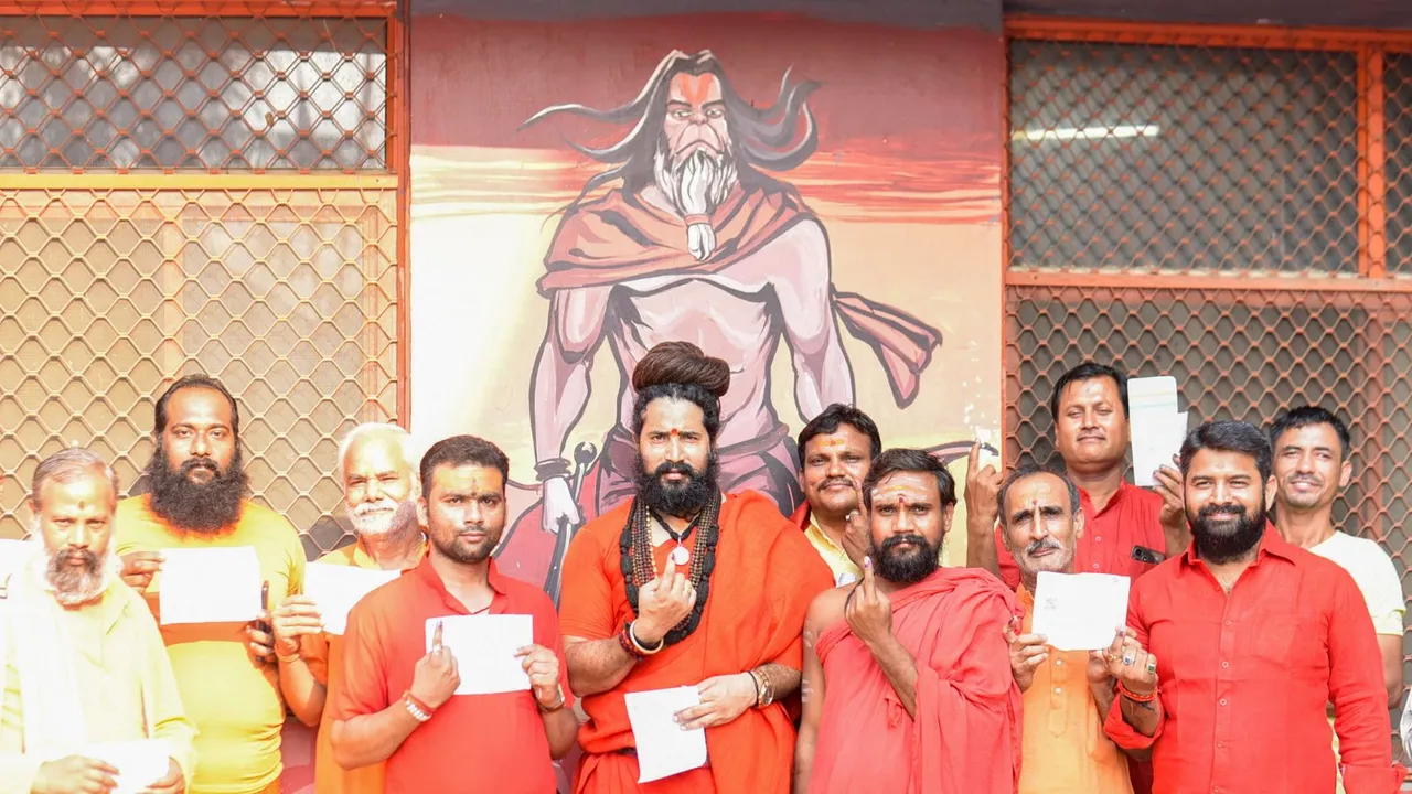 Mahant of Baghambari Math Balveer Giri Maharaj (C) after casting his vote at a polling booth during the sixth phase of Lok Sabha elections, in Prayagraj, Saturday, May 25, 2024