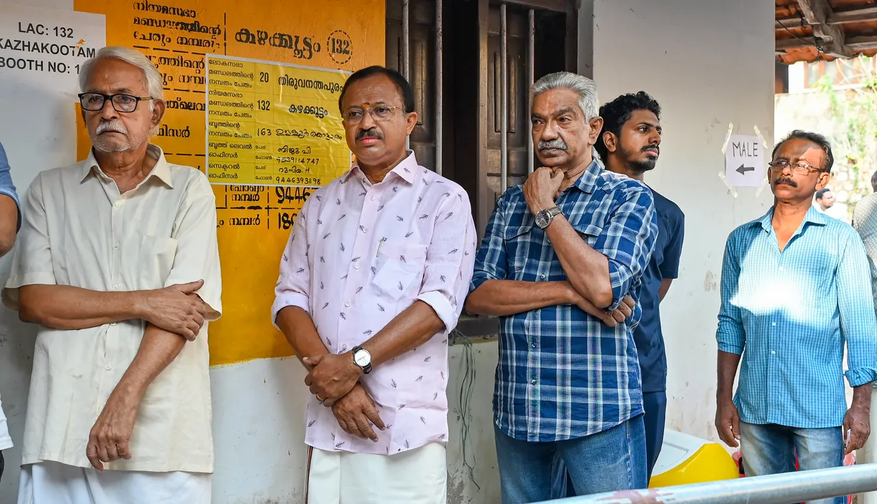 Union Minister V Muraleedharan stand in queue at polling centre in Kerala