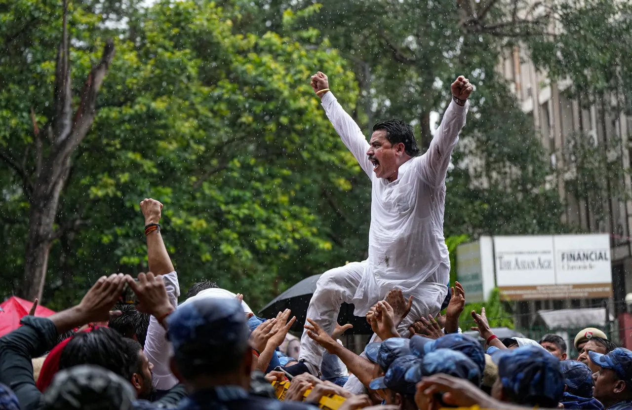 A worker of Delhi BJP raises slogans during a protest against the AAP government over waterlogging in different parts of the national capital during Monsoon rainfall, in New Delhi, Monday.jpg