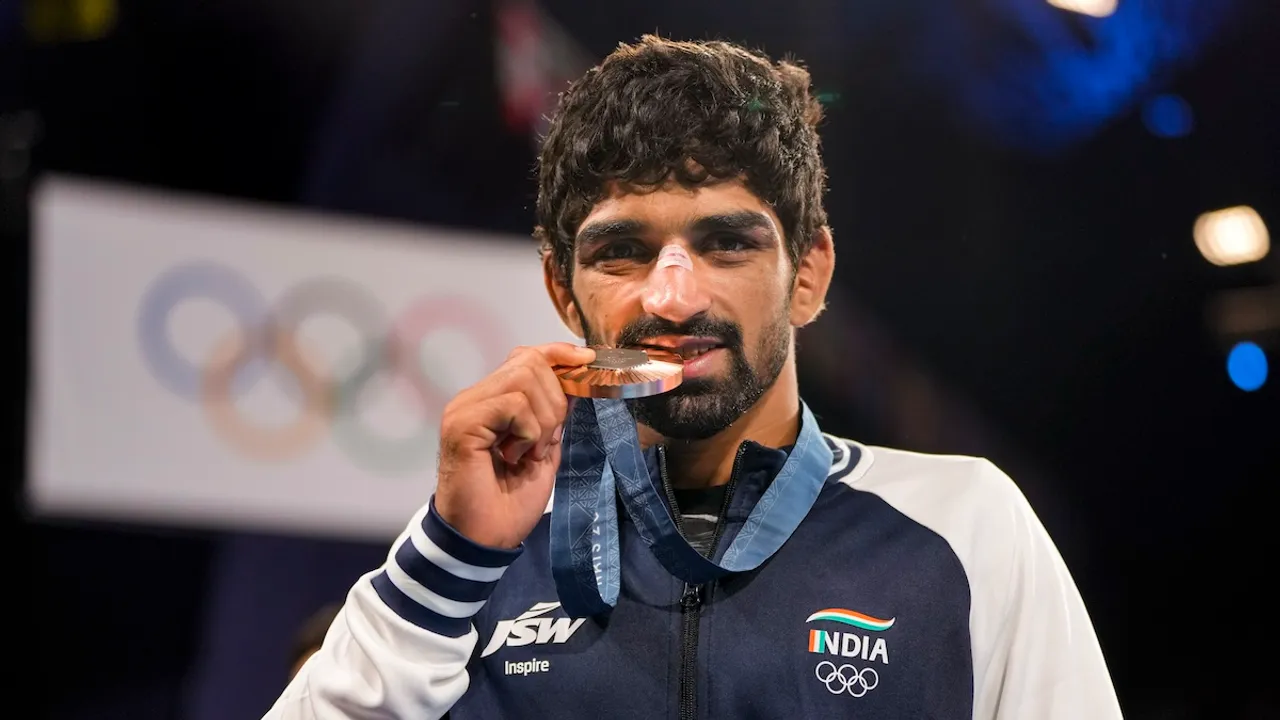 Bronze medalist India's Aman Sehrawat poses for photos at the podium during the victory ceremony for the men's 57kg free-style wrestling event at the 2024 Summer Olympics, in Paris, France, Friday, Aug. 9, 2024.