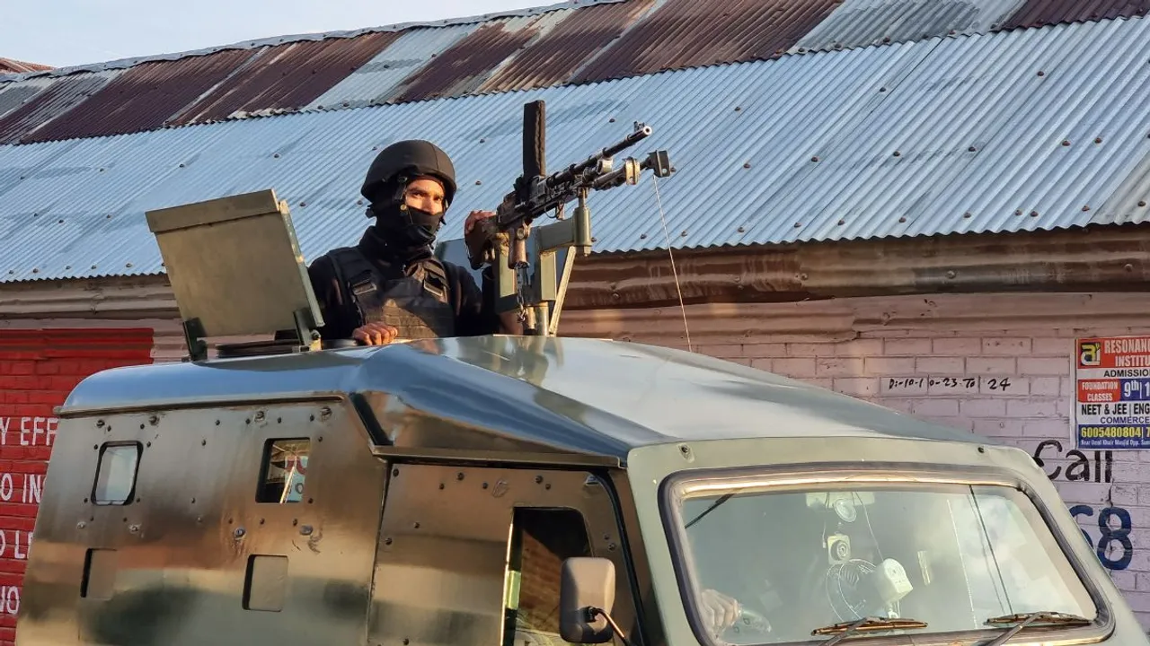 A security personnel stands guard during an encounter with terrorists, in Nowpora area of Sopore district, Friday, April 26, 2024