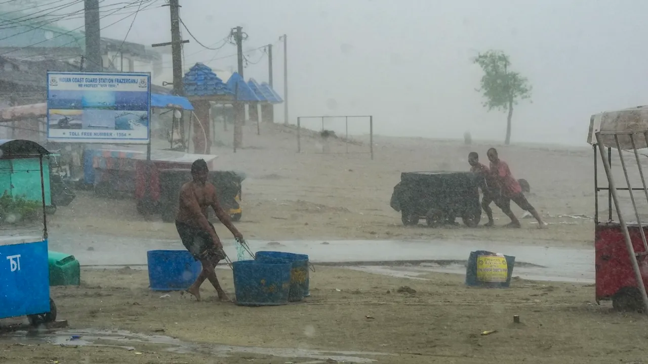 People move their belongings away from the seashore amid rain, ahead of the landfall of Cyclone 'Remal', in South 24 Parganas district, Sunday, May 26, 2024.