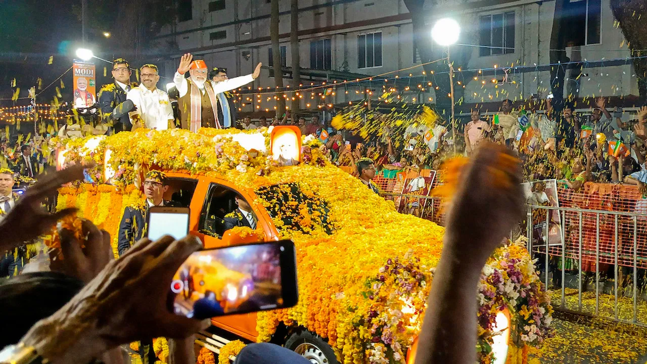 Narendra Modi waves to supporters during a roadshow, in Ernakulam district, Tuesday, Jan. 16, 2024.