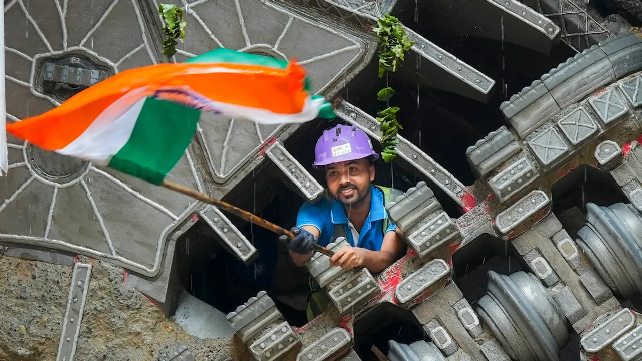 A worker celebrates after the successful breakthrough of the Tunnel Boring Machines (TBMs) 'Bhoomi' and 'Srishti' at the Pulbangash metro station site of the Delhi Metro's Phase-4 expansion, in New Delhi, Wednesday, Sept. 18, 2024.