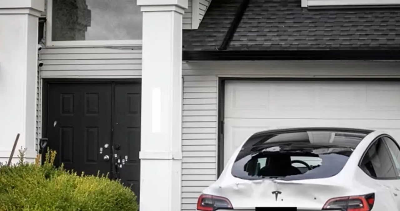 Bullet holes are pictured in a vehicle parked outside a home near the 2800 block of 154 Street in Surrey, B.C., on Thursday