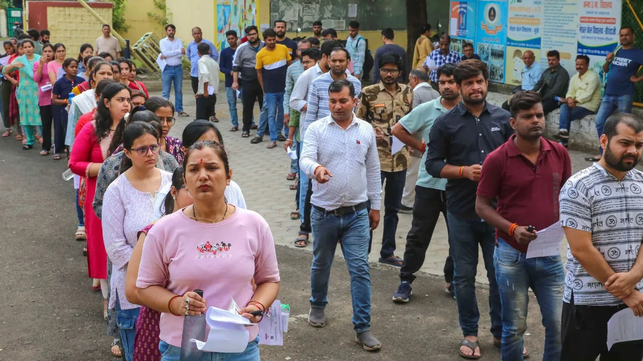 Aspirants wait outside an examination center before appearing in the Madhya Pradesh Public Service Commission (MPPSC) Preliminary Examination, in Bhopal, Sunday, June 23, 2024.