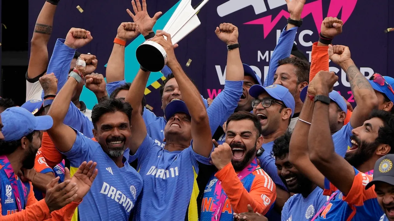 India's head coach Rahul Dravid, center left, and Virat Kohli, center right, celebrate with players and team support staff with the winners trophy after defeating South Africa in the ICC Men's T20 World Cup final cricket match at Kensington Oval in Bridgetown, Barbados, Saturday, June 29, 2024.