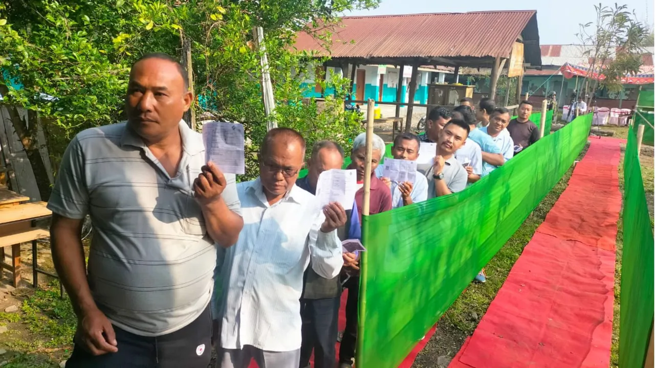 Voters wait in a queue at a polling station to cast their votes for the first phase of Lok Sabha elections, in Luwangsangbam, Manipur, Friday, April 19, 2024