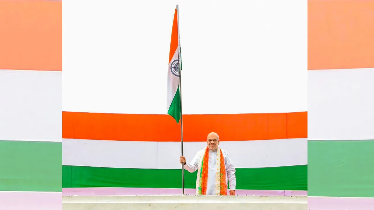 Union Home Minister Amit Shah hoists the national flag atop his residence as part of the Har Ghar Tiranga campaign.