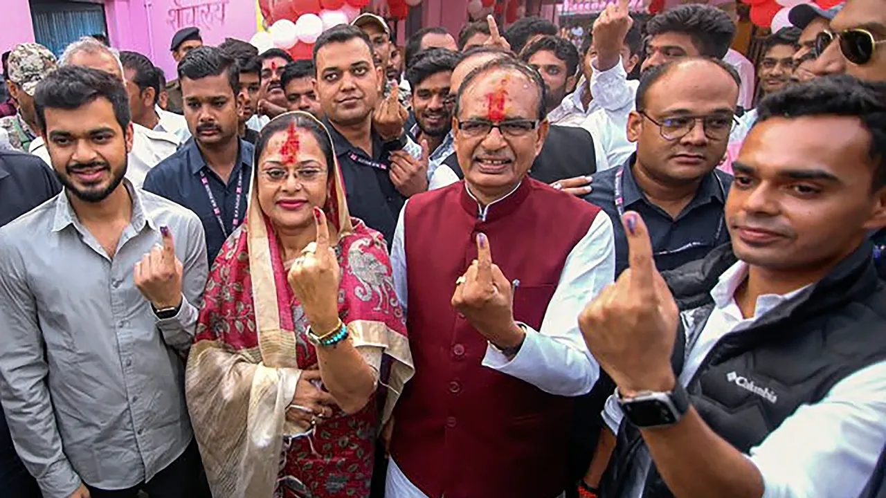 Madhya Pradesh Chief Minister Shivraj Singh Chouhan and his wife Sadhna Singh show their fingers marked with indelible ink after casting their votes for the State Assembly elections