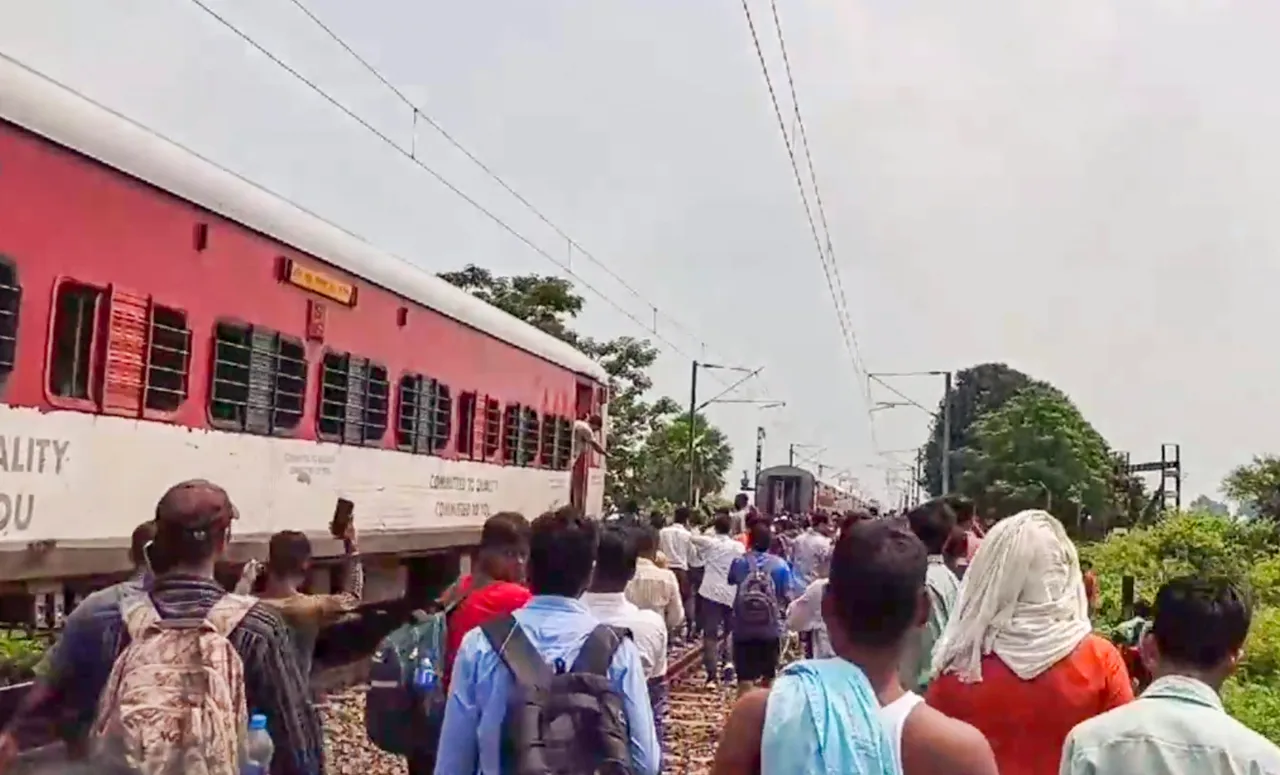 Passengers on railway tracks after coaches of Magadh Express train splitted into two parts following an accident near Tudiganj station, in Buxar, Sunday, Sept. 8, 2024.
