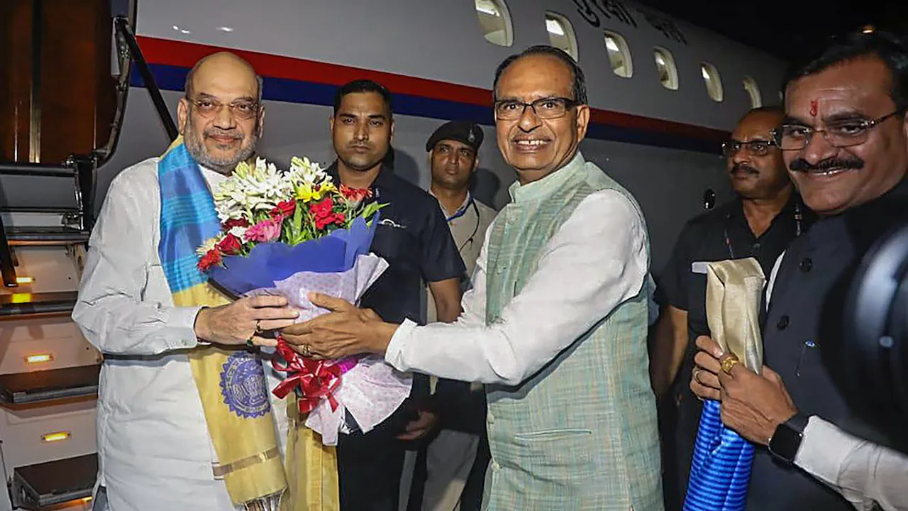 Union Home Minister Amit Shah being welcomed by Madhya Pradesh Chief Minister Shivraj Singh Chouhan upon his arrival, in Bhopal, Tuesday, July 11
