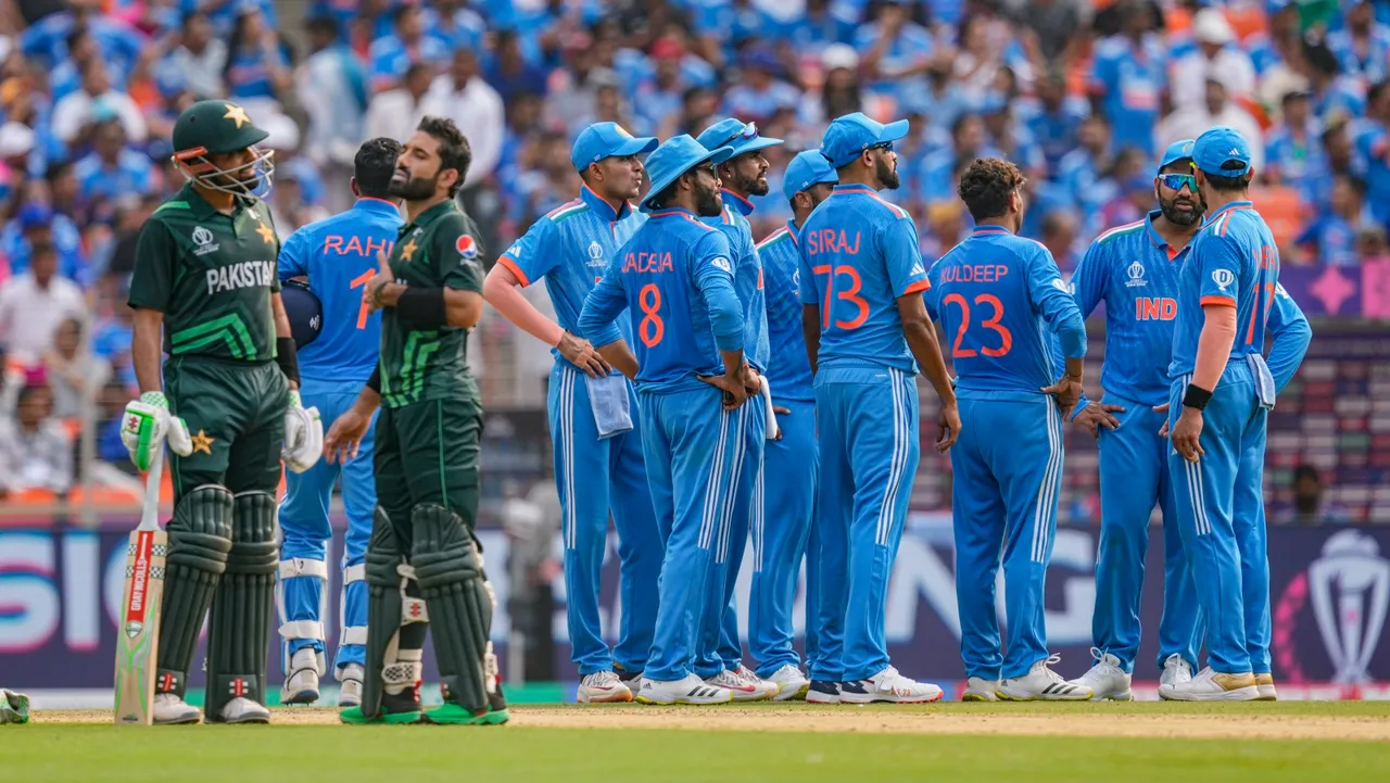 Pakistan's Babar Azam and Mohammad Rizwan wait for the decision of review as Indian players look on during the ICC Men's Cricket World Cup 2023 match between India and Pakistan