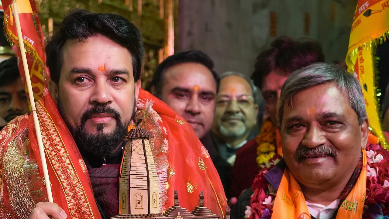 Union Minister Anurag Singh Thakur with NDMC Vice Chairman Satish Upadhyay holds a model of the Shri Ramjanmbhoomi Mandir