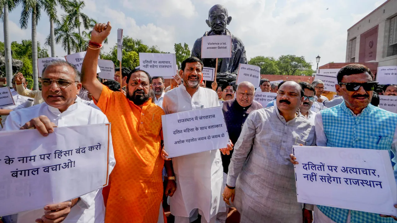 BJP Rajasthan MPs along with senior leaders stage a protest in front of the Gandhi statue against Rajasthan Chief Minister Ashok Gehlot, at Parliament House complex in New Delhi, Monday, July 24