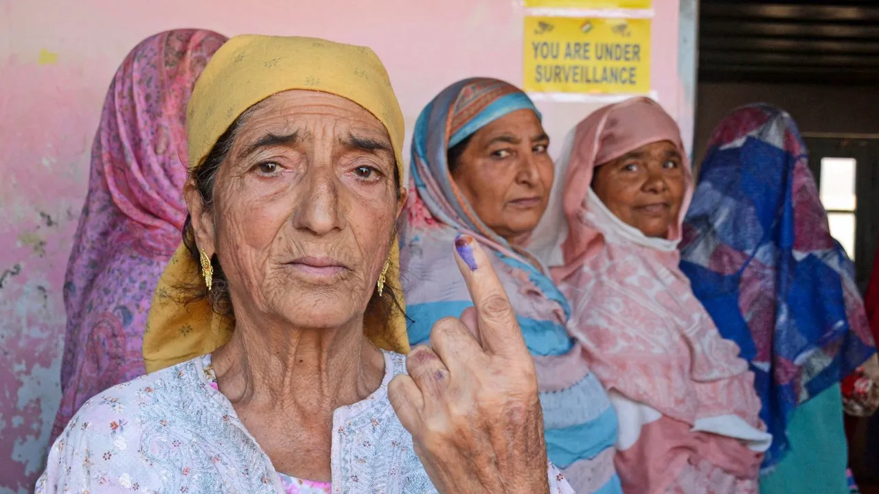 An woman shows her finger marked with indelible ink after casting vote at a polling station during the third and final phase of the Jammu and Kashmir Assembly elections, Singhpora, in Baramulla district, Tuesday, Oct. 1, 2024.