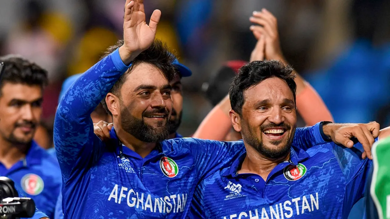 Afghanistan's captain Rashid Khan with teammate Gulbadin Naib acknowledges fans after Afghanistan won the ICC Men's T20 World Cup cricket match against Bangladesh, at Arnos Vale Ground, Kingstown, Saint Vincent and the Grenadines, Monday, June 24, 2024