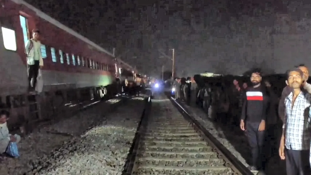 Peple gather after coaches of the Sabarmati Express passenger train derailed between Kanpur and Bhimsen station in Uttar Pradesh, Saturday, Aug. 17, 2024.