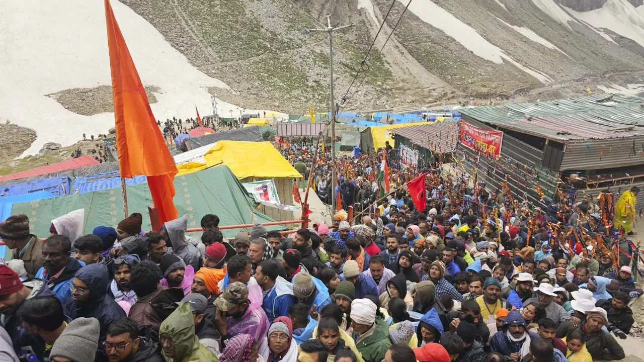 Devotees arrive at the Amarnath Temple to offer prayers during the annual Amarnath Yatra, in Anantnag district, Sunday, July 7, 2024