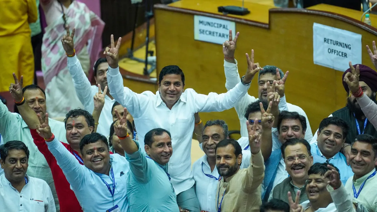 BJP candidate Sunder Singh Tanwar with other party councillors shows victory sign after the MCD's Standing Committee member election, at MCD House in New Delhi, Friday, Sept 27, 2024.