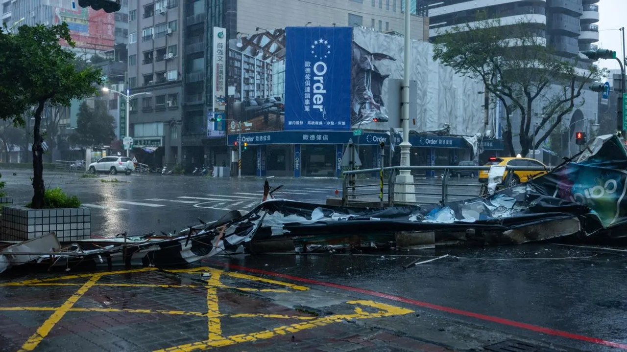 A commercial sign is blown off along a street by strong wind as Typhoon Krathon makes landfall on October 03, 2024 in Kaohsiung, Taiwan
