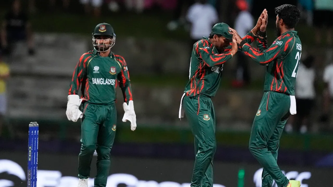 Bangladesh's Rishad Hossain, right, celebrates with teammates after taking the wicket of Australia's captain Mitchell Marsh during the ICC Men's T20 World Cup cricket match between Australia and Bangladesh in North Sound, Antigua and Barbuda, Thursday, June 20, 2024.