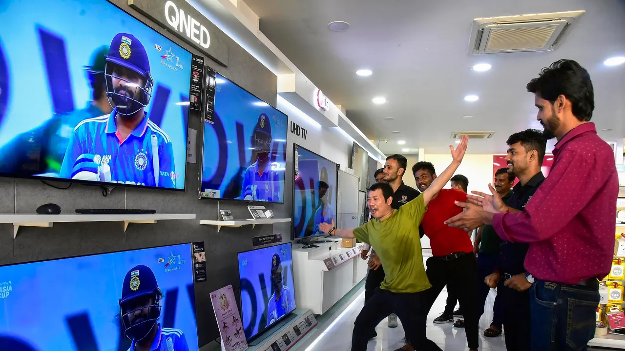 People watch Asia Cup cricket match between India and Pakistan, at a TV showroom, in Bikaner
