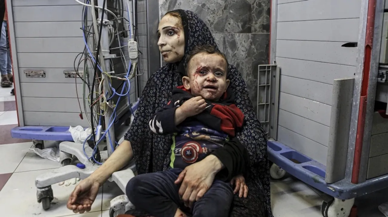 Wounded Palestinians wait for treatment in al-Shifa hospital in Gaza City