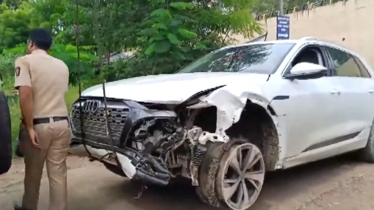 A police personnel near the damaged Audi owned by Maharashtra BJP chief Chandrashekhar Bawankule's son Sanket Bawankule, after it allegedly hit several vehicles, in Nagpur, Tuesday, Sept 10, 2024.