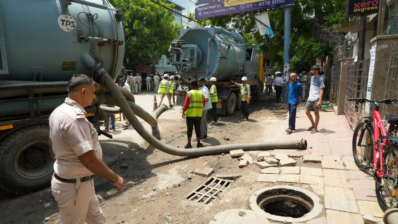 Vacuum trucks parked near a UPSC exam coaching centre to pump out water from the flooded basement of the coaching centre, in New Delhi, Sunday, July 28, 2024.