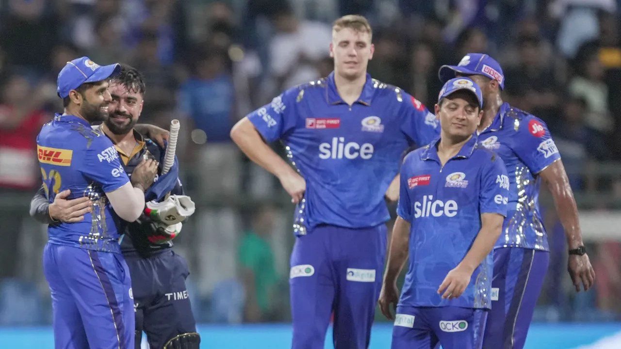 Gujarat Titans batter Rashid Khan greets Mumbai Indians player Suryakumar Yadav on May 12