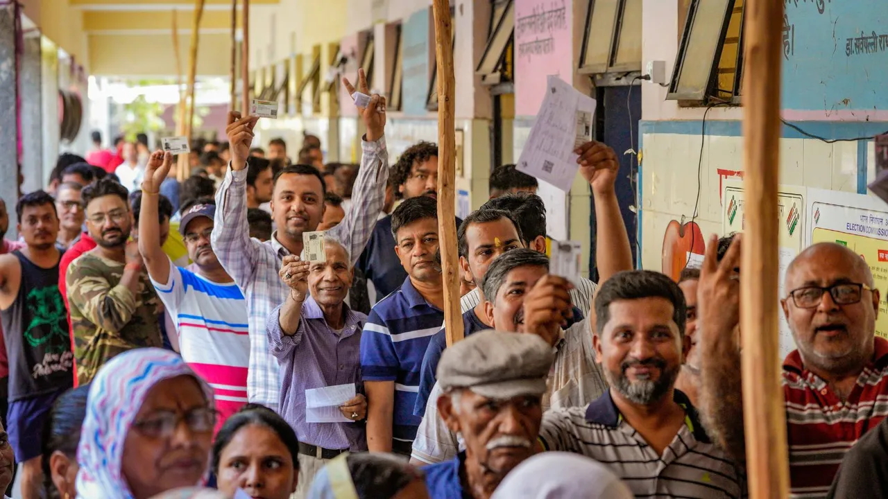 People show their identity cards as they wait in a queue to cast vote at a polling station under East Delhi constituency during the sixth phase of Lok Sabha elections, in New Delhi, Saturday, May 25, 2024