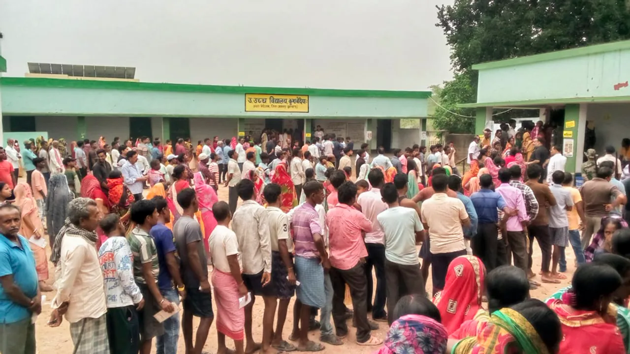 People wait a polling station to cast their votes in the seventh and last phase of Lok Sabha elections, in Jamtara district of Jharkhand, Saturday, June 1, 2024.