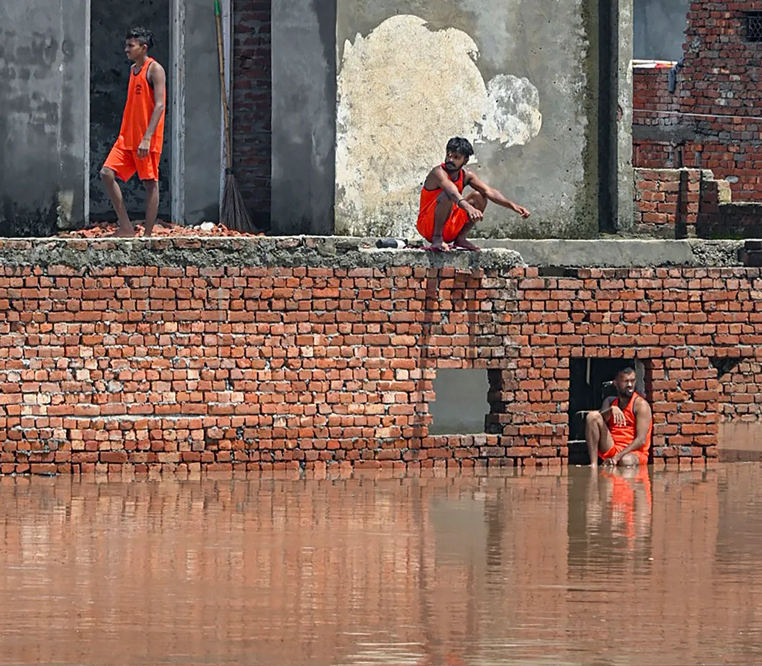 Floodwaters of the swollen Badi Nadi river inundates a locality, in Patiala district, Wednesday.jpg