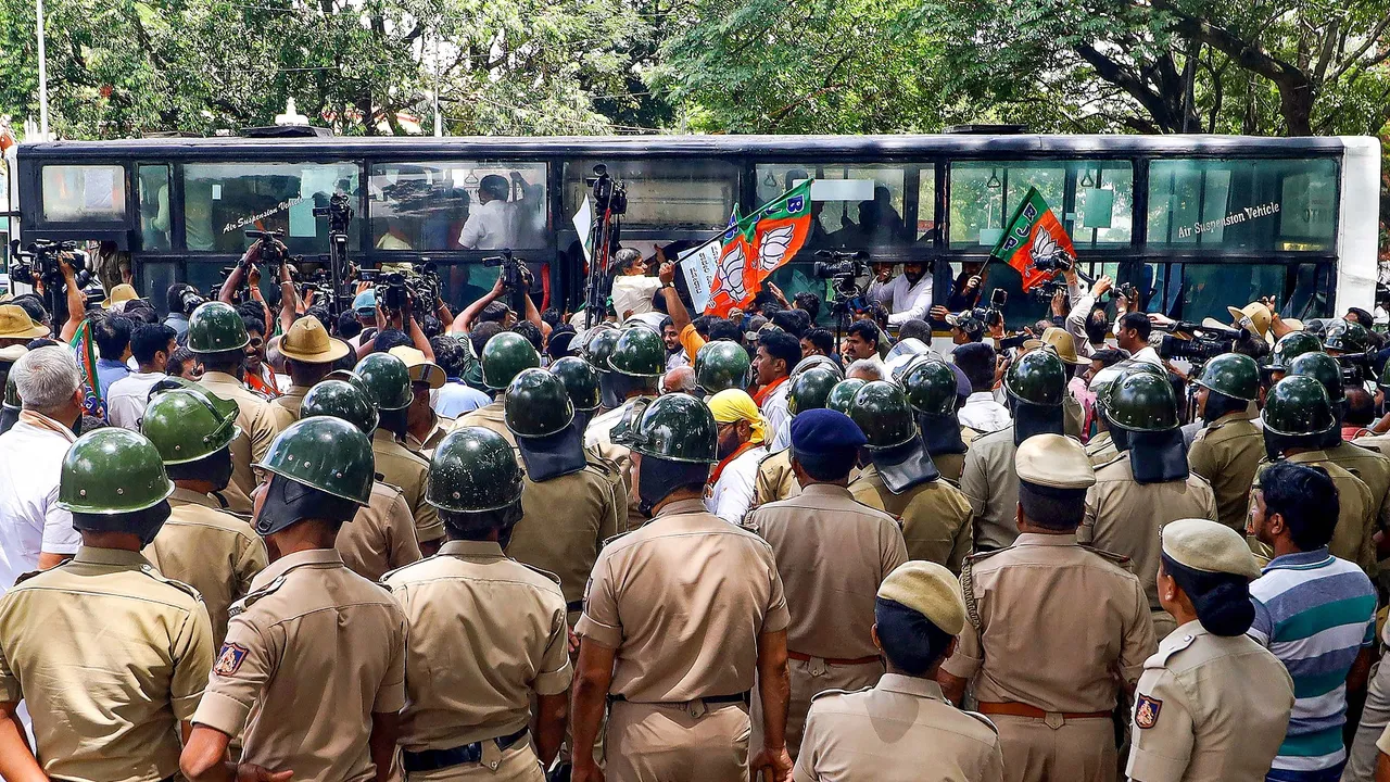 Police detain BJP workers protesting against the release of Cauvery river water to Tamil Nadu from dams in Karnataka, in Bengaluru