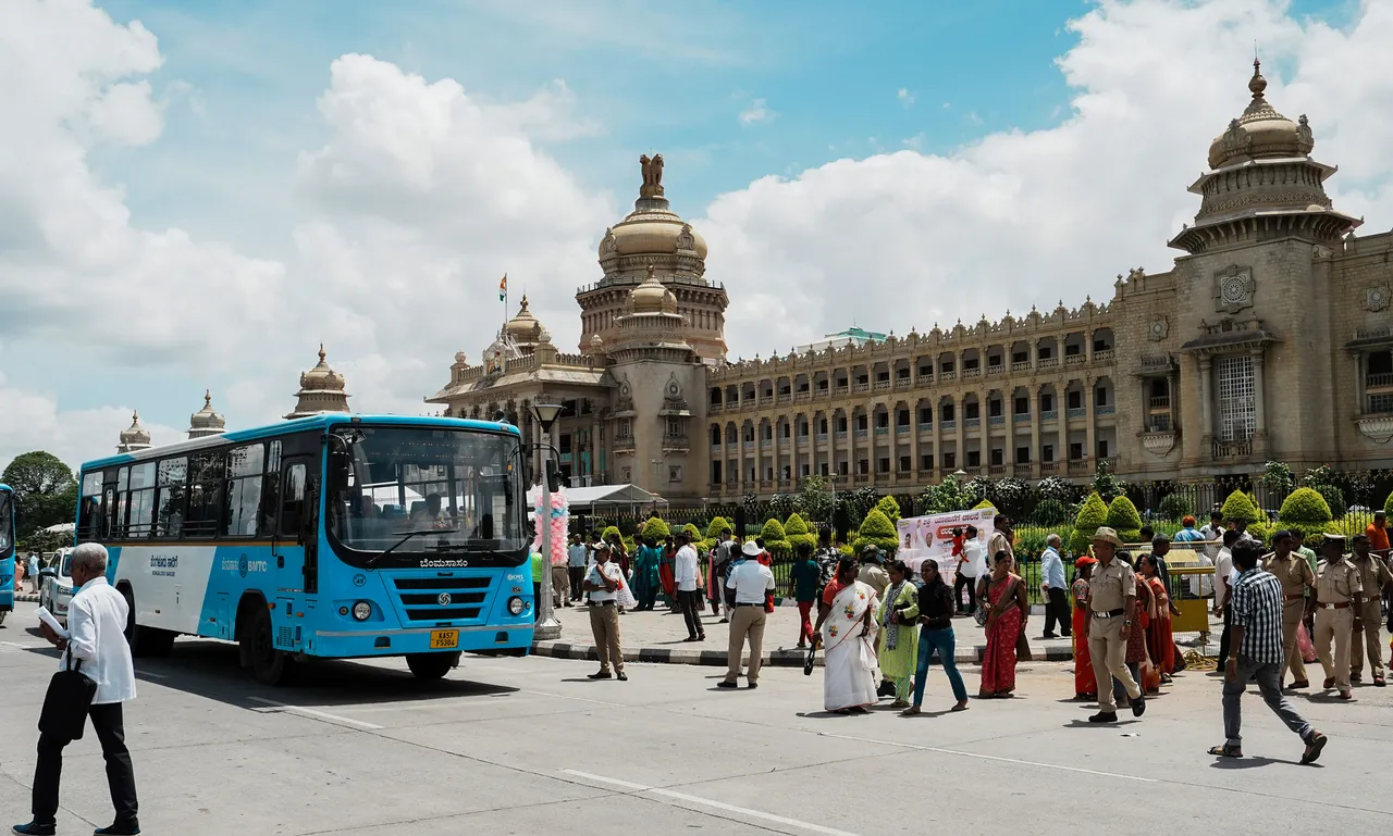 Women wait to board a bus after the launch of the 'Shakti Scheme', at Vidhana Soudha in Bengaluru