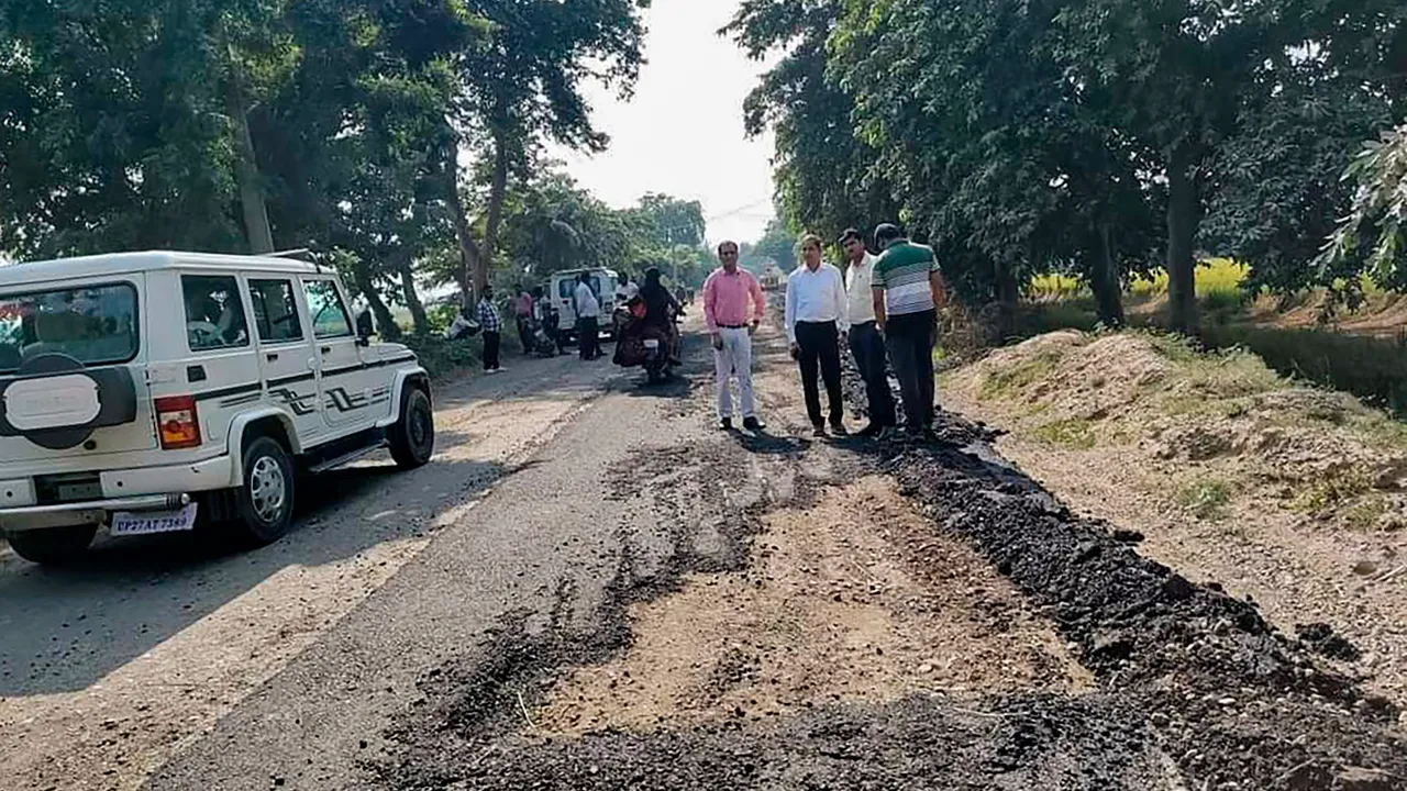 Officials at the site after a half-a-kilometre stretch of a road laid by the Public Works Department (PWD) was dug up with the help of a bulldozer allegedly by a representative of a BJP MLA for non-payment of commission by the contractor, in Shahjahanpur,