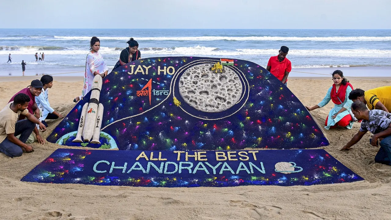 Students of Sudarsan Sand Art Institute create a sand art on ISRO’s lunar mission Chandrayaan-3 at the beach, in Puri