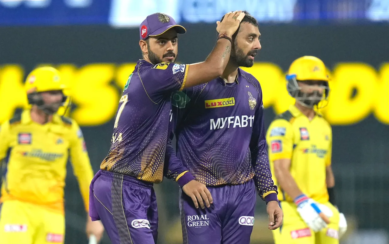 Kolkata Knight Riders bowler Varun Chakravarthy celebrates with team captain Nitish Rana after the wicket of Chennai Super Kings batter Ajinkya Rahane